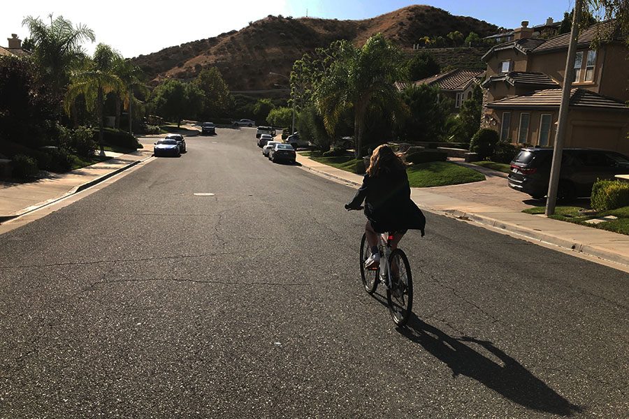 Our author channels Rue as she rides her bike through her very own suburban street.