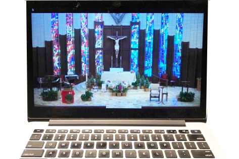 From her couch instead of from the pews, the author attends Sunday mass at St. Bedes via livestream. 
