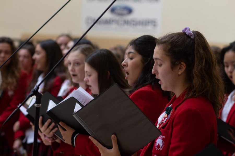 Choir student Julieanna Gonzalez '21  (second from right) sings to her heart's content during a mass from the 2019-2020 school year.