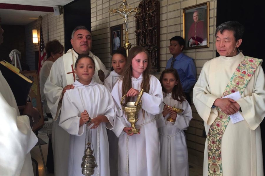 Growing up, becoming an altar server in the Catholic Church was common for many kids. Pictured above is the author, Siena Urquiza ‘23 (left) altar serves for her Church, St. Bede in 2015.
