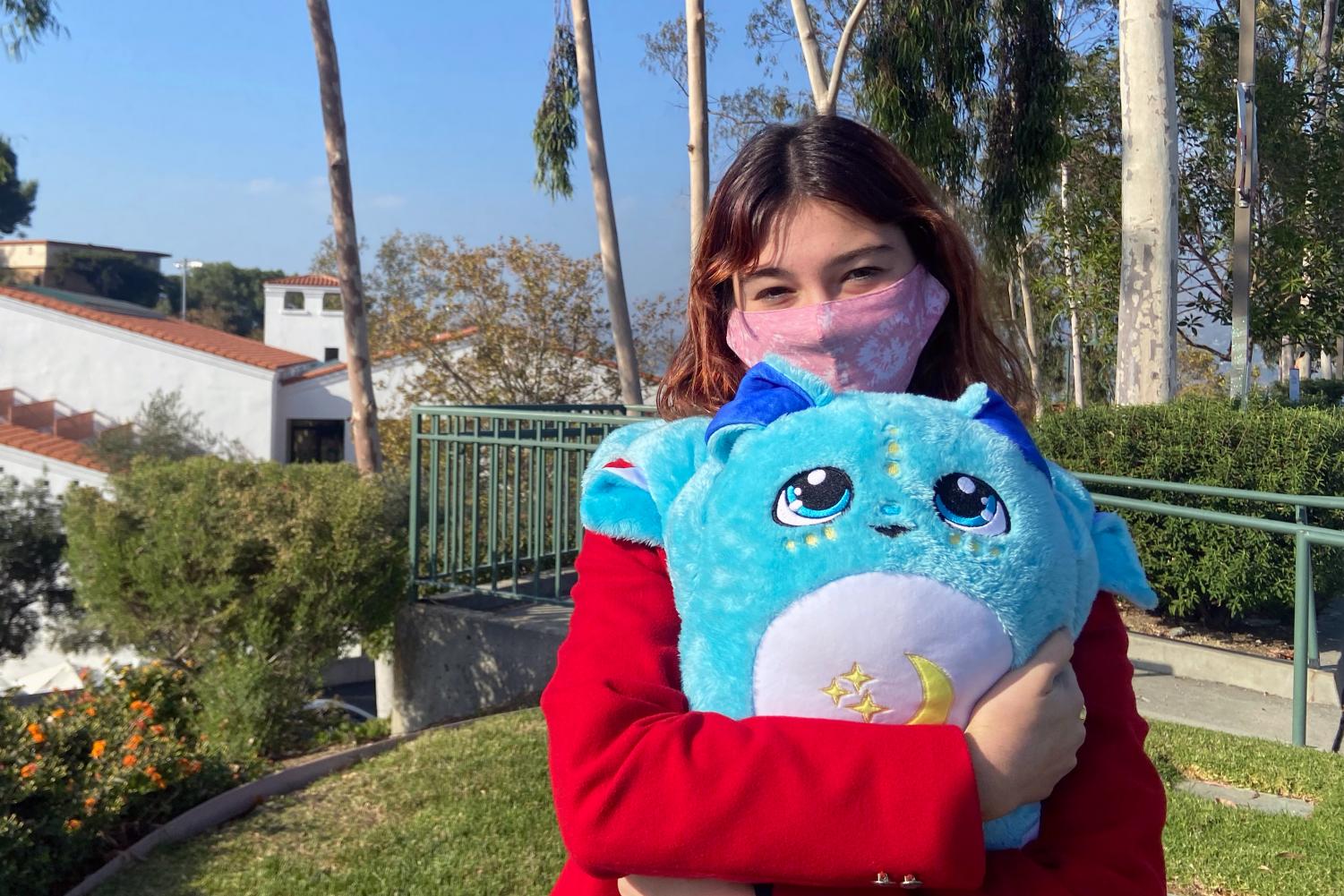 Caitlin Hubbs ‘22 hugs her early Christmas gift, a Moon Pal plush, which spent a year at the top of her wish list.