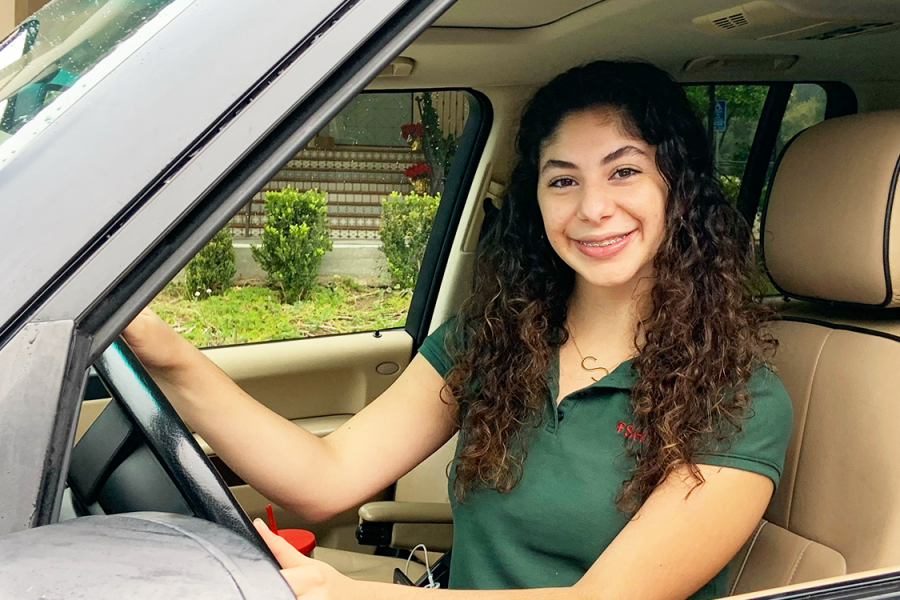 Sophia Durand 24, a new sophomore driver at FSH, poses behind the wheel. 
