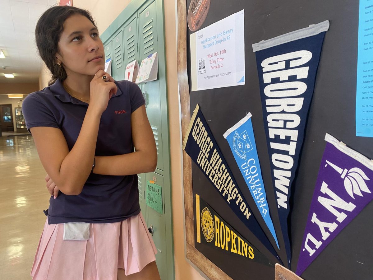 Annie Ramirez ‘24 contemplates her future in front of the College Counseling Board in the Senior Hallway. 