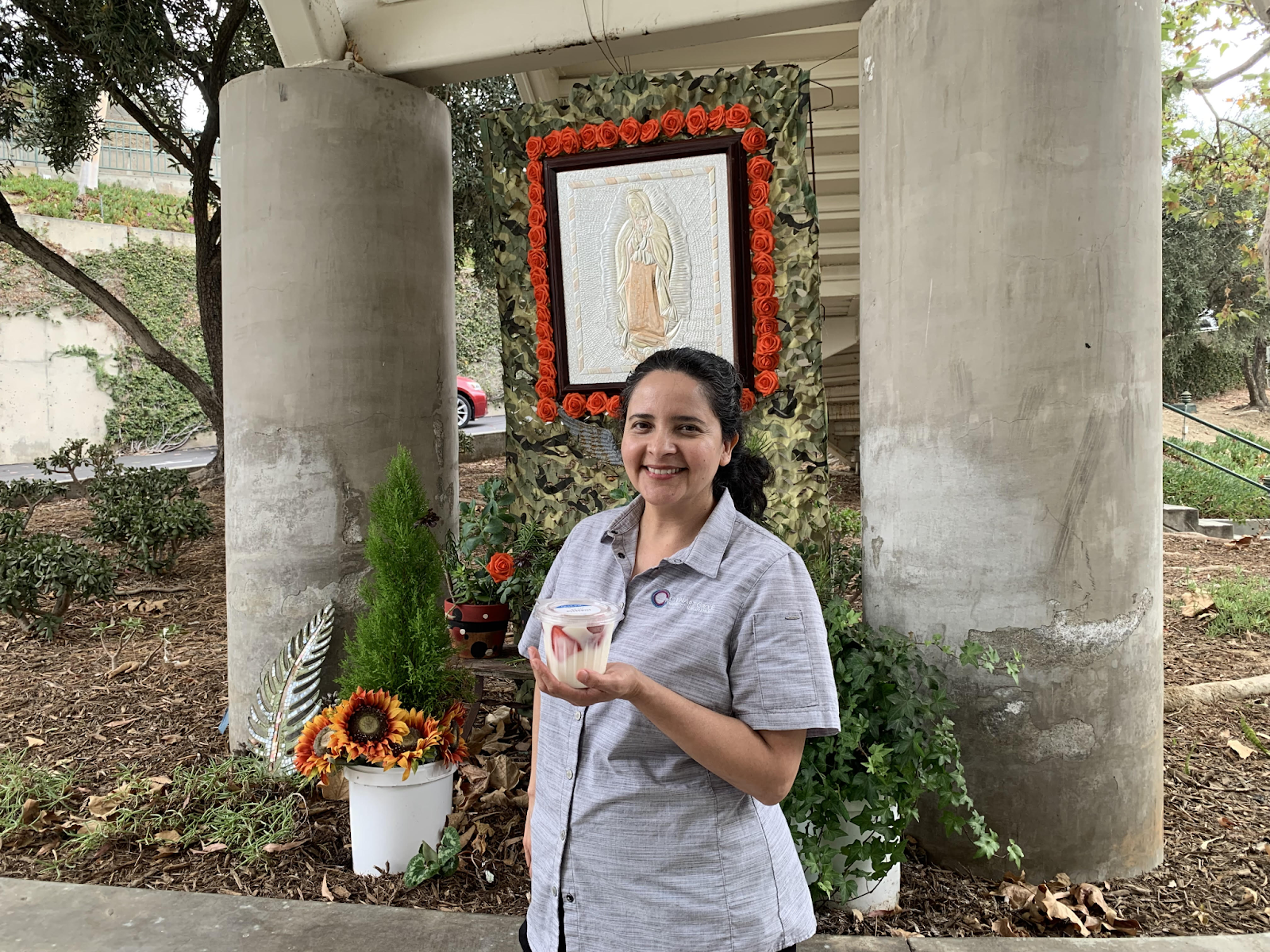 Tologcafe Cashier Saida Seien poses with the new everyday yogurt parfait snack option. Photo by Daniela Munguia ‘26. 