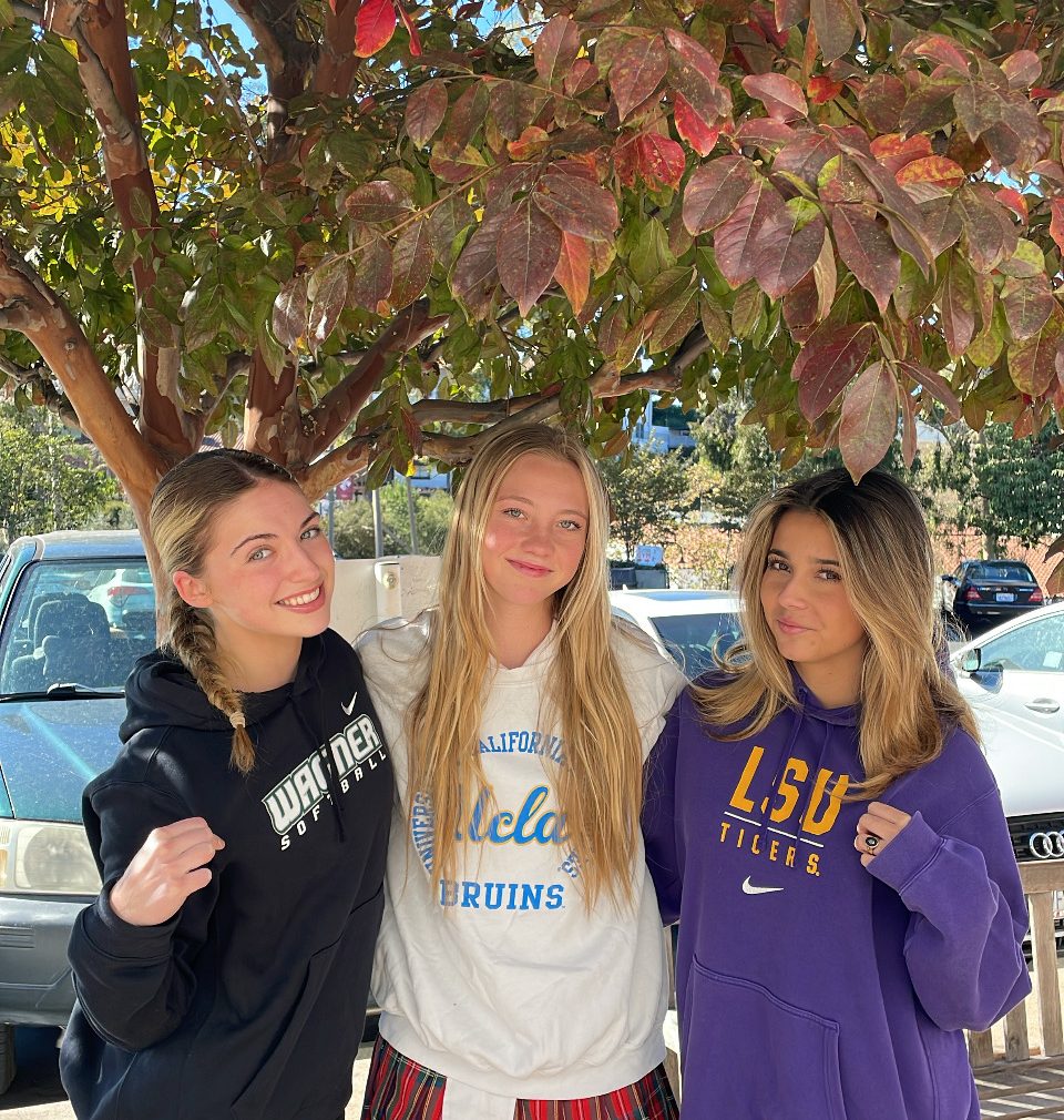 Ava Nawrocki '25, Piper Scherbert '25, and Emma Gordo '25 seen wearing sweatshirts of their favorite colleges and universities. 