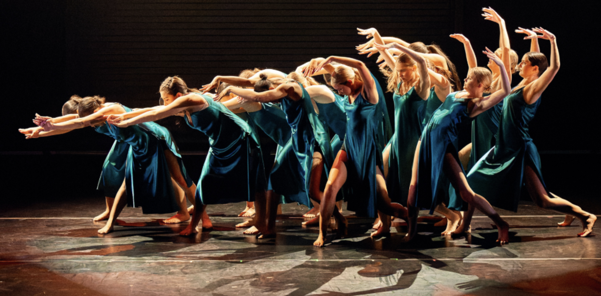 Dancers hovering in transition, while performing “After We Leave, Before We Arrive,” choreographed by Layla Adams. Photo by George Simian.