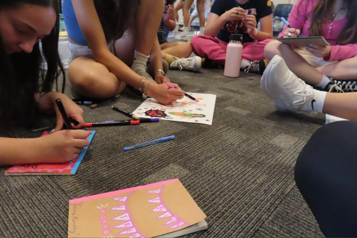 Tologs seen coloring and decorating their journals.
